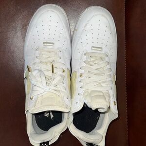 Nike White Low-Top Sneakers with Gold Accents